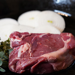 Foggy Bottoms Boys Ribeye in a cast iron pan with onions and mint